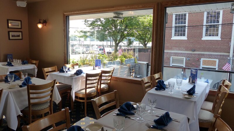 Upstairs dining room with set tables with view of window