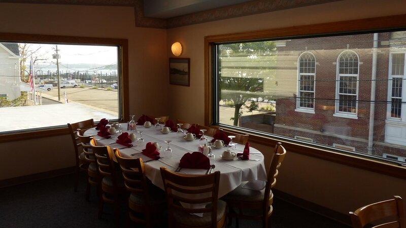 Upstairs dining room with set table for 10 with view of window